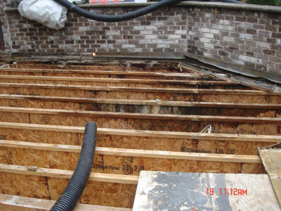 Deck joists remaining after rotted wood was removed from failed tile deck