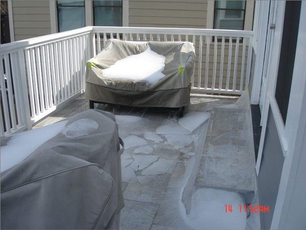 Tile deck that was not waterproofed and is protected with a plastic sheet.