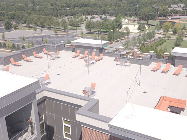 Roofing approved Duradek vinyl membrane protecting living space below massive leisure roof deck.