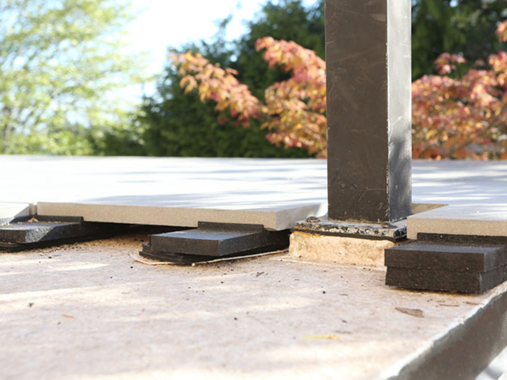 Duradek's Plazadek System with pavers on pedestals and raised base plate ofp