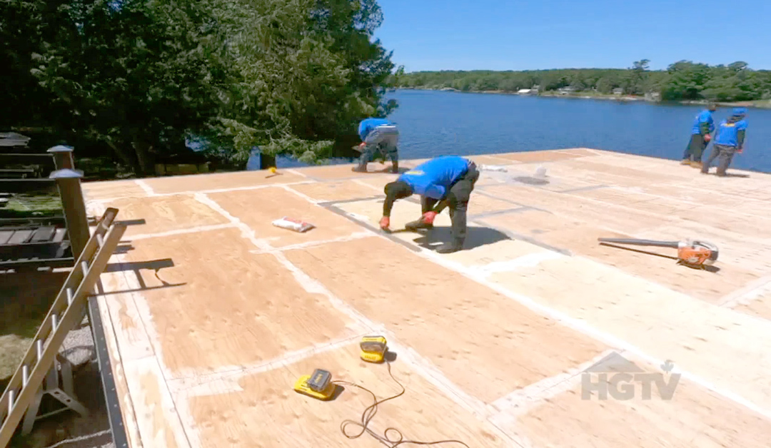 Duradek applicators prepare the substrate in a boathouse roof deck renovation.