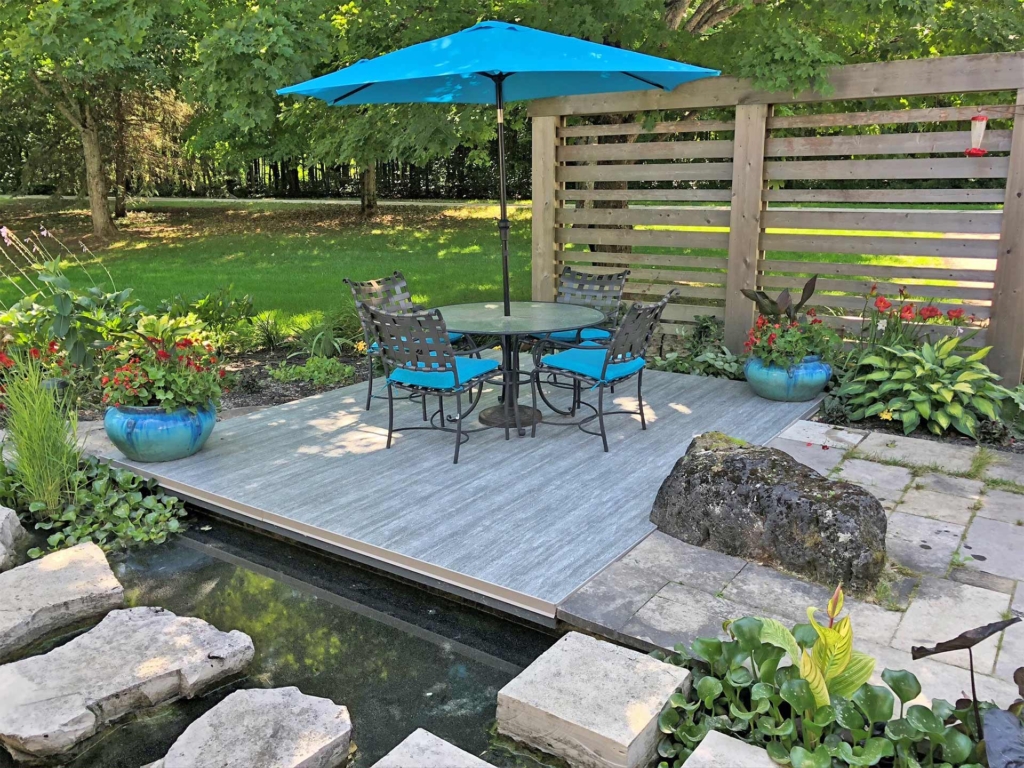 backyard patio with Duradek vinyl decking and blue patio set