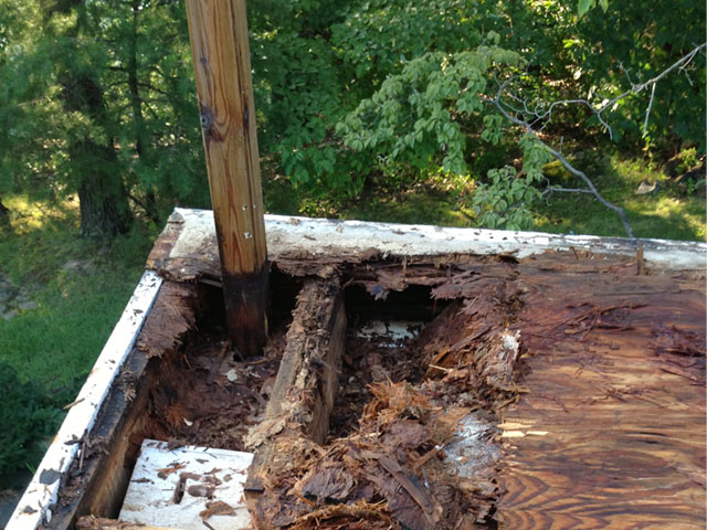 wood rot on deck from waterproofing failure at railing